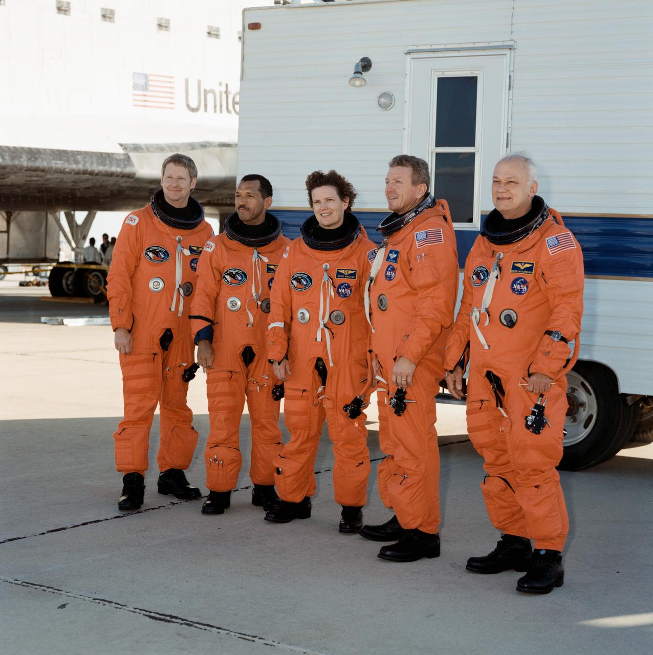 STS031-S-130 (29 April 1990) --- The astronauts of STS-31 pose for a quick photo near the Space Shuttle Discovery following a smooth landing on the runway at Edwards Air Force Base to complete a highly successful five-day mission.  Pictured, left to right, are Astronauts Steven A. Hawley, Charles F. Bolden Jr., Kathryn D. Sullivan, Loren J. Shriver, and Bruce McCandless II.  Theirs was an Earth orbital flight during which the Hubble Space Telescope (HST) was sent toward its 15-year mission.