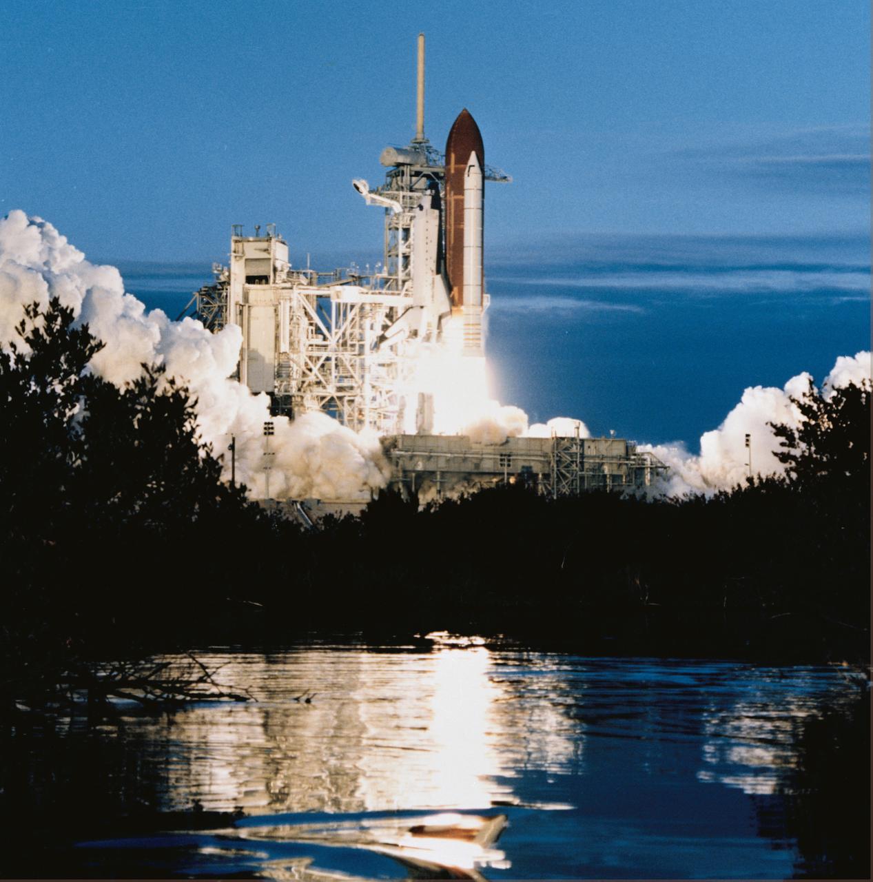 STS032-S-069 (9 Jan. 1990) --- The space shuttle Columbia, with a five member crew aboard, lifts off for the ninth time as STS-32 begins a 10-day mission in Earth orbit. Leaving from Launch Pad 39A at 7:34:59:98 a.m. EST, in this horizontal (cropped 70mm) frame, Columbia is seen reflected in nearby marsh waters some 24 hours after dubious weather at the return-to-launch site (RTLS) had cancelled a scheduled launch. Onboard the spacecraft were astronauts Daniel C. Brandenstein, James D. Wetherbee, Bonnie J. Dunbar, G. David Low and Marsha S. Ivins. Photo credit: NASA