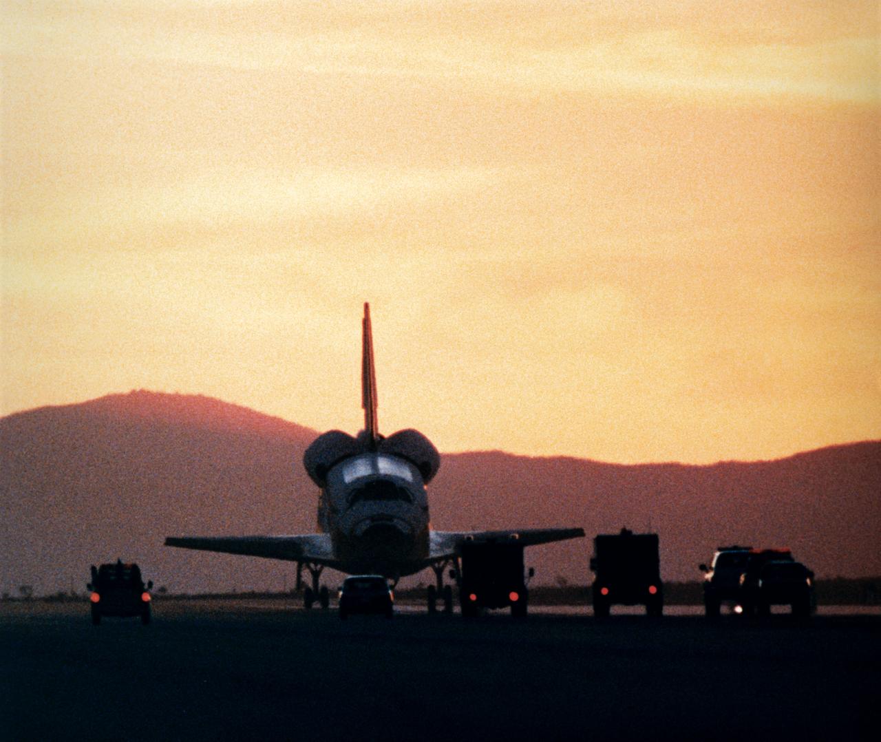 STS033-S-017 (27 Nov 1989) --- The Space Shuttle Discovery is approached by safing vehicles and team members following its late-afternoon landing at Edwards Air Force Base in southern California.  A five member crew aboard had just completed the DOD-devoted      STS-33 mission.  The landing occurred at     16:31:02 p.m. (PST), Nov. 27, 1989.  Onboard   Discovery for the mission and still aboard the   craft when this photo was made were Astronauts   Frederick D. Gregory, John E. Blaha, Kathryn C. Thornton, F. Story Musgrave and Manley L.   Carter.