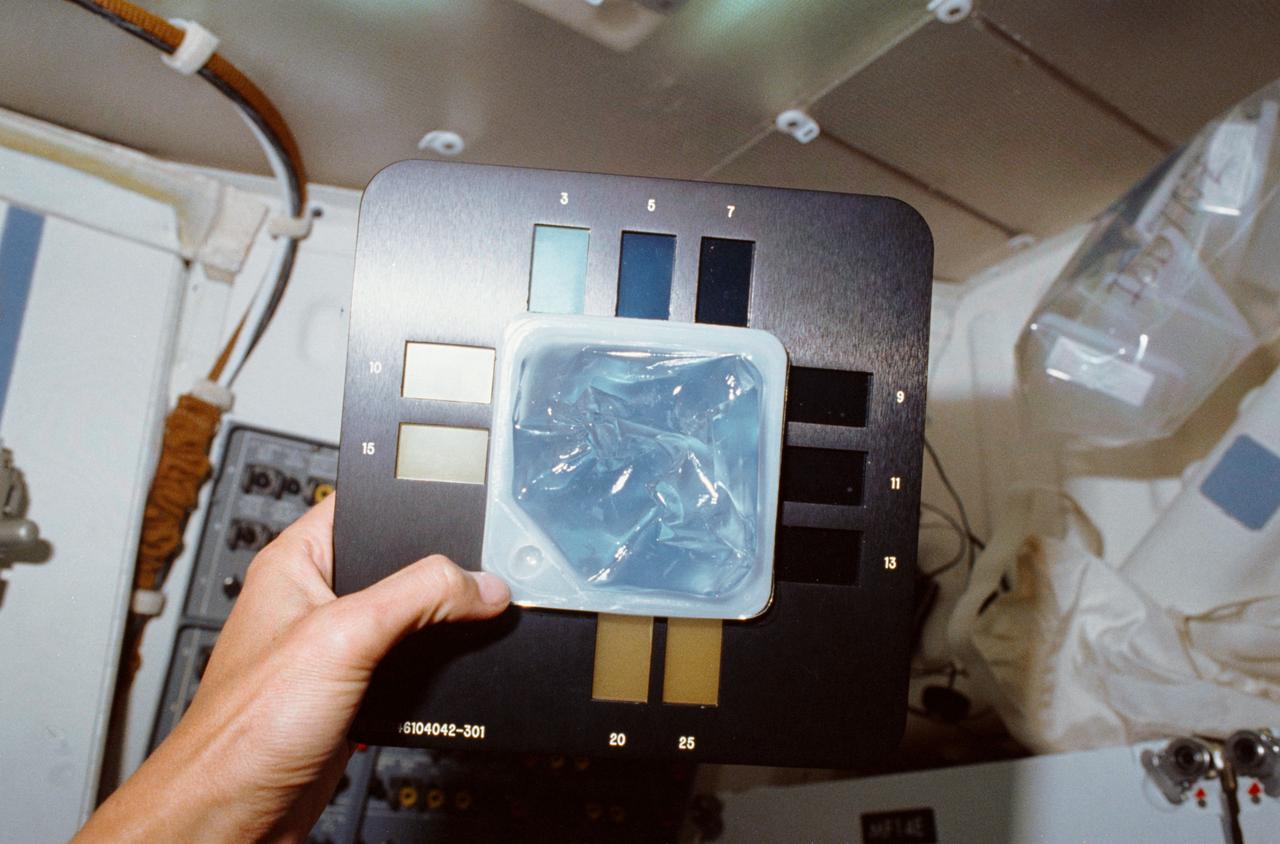 STS034-10-014 (18-23 Oct. 1989) --- An onboard 35mm camera provides a closeup view of an STS-34 beverage container doubling as an experiment module for a test involving iodine concentration in onboard water.  The examination called for the adding of starch to a specimen of Atlantis' fuel-cell produced water.  The liquid was then compared against the color chart for determining the degree of iodine content.  The experiment was designed by Terry  H. Slezak of JSC's Photographic Technology and Television Division.