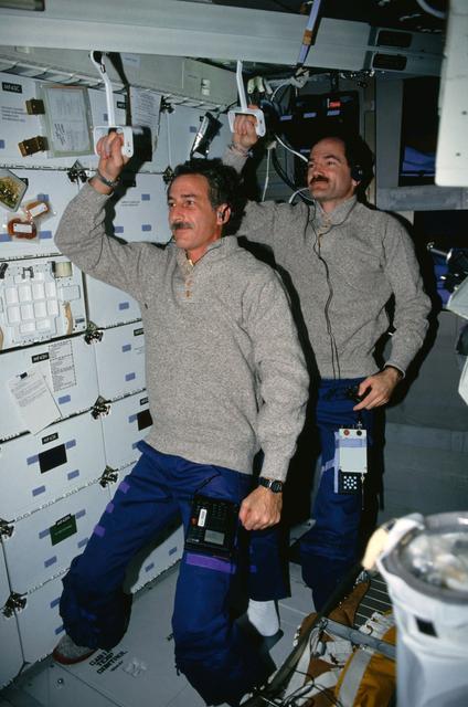 NASA image: STS-35 MS Hoffman & Pilot Gardner "commute" to work on the middeck of OV-102
