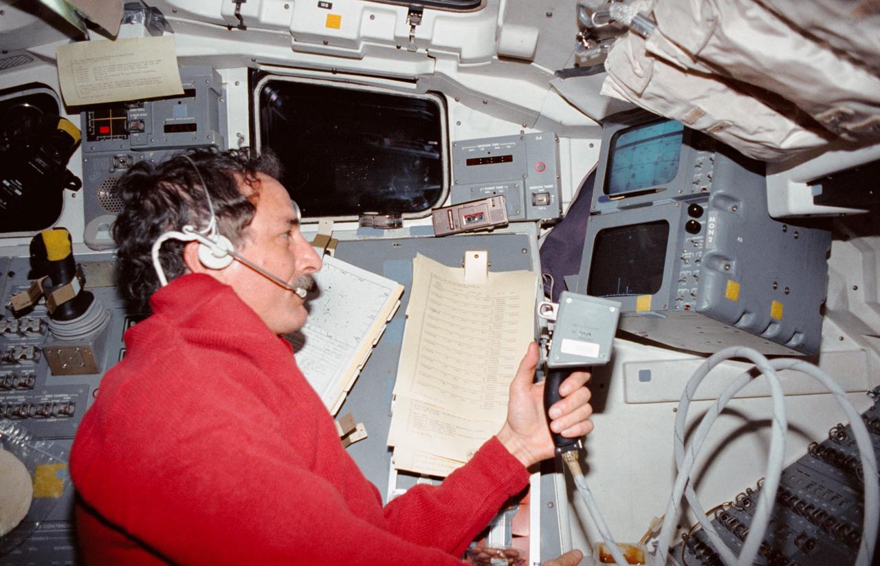 STS035-12-015 (2-11 Dec 1990) --- Astronaut Jeffrey A. Hoffman, STS 35 mission specialist, uses a manual pointing controller (MPC) for the Astro-1 mission's Instrument Pointing System (IPS).   By using the MPC,  Hoffman and other crewmembers on Columbia's aft flight deck,  were able to command the IPS, located in the cargo bay, to record astronomical data.  Hoffman is serving the "Blue" shift which complemented the currently sleeping "Red" shift of crewmembers as the mission collected scientific data on a 24-hour basis.  The scene was photographed with a 35mm camera.