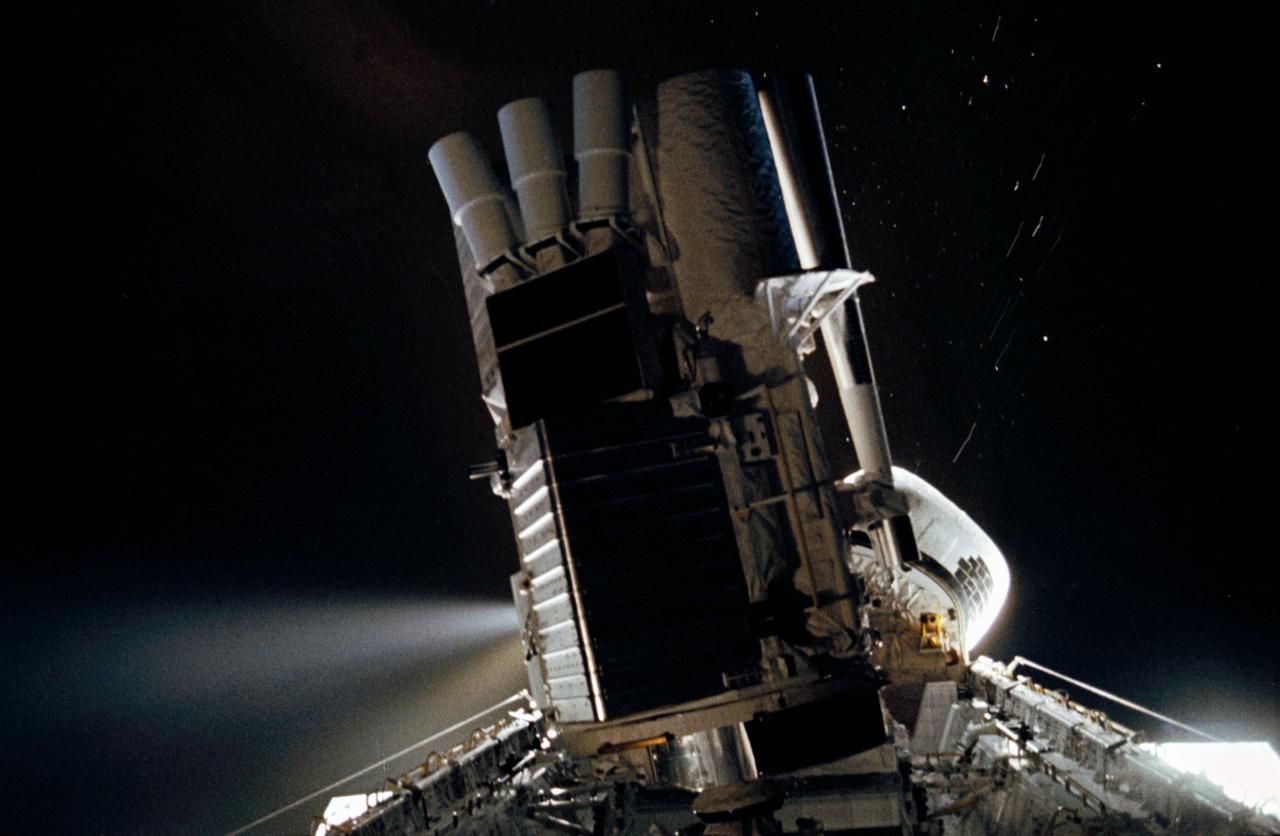 STS035-35-007 (2-10 Dec 1990) --- During the STS-35 mission, the Astronomy Laboratory 1 (ASTRO-1) payload, in its on-orbit operating configuration in the payload bay (PLB), is silhouetted against the firing of a reaction control system (RCS) jet. In the center of the frame, three ultraviolet telescopes are mounted and precisely co-aligned on a common structure, called the cruciform, that is attached to the instrument pointing system (IPS). Visible on the cruciform are Integrated Radiator System (IRS) (silver box on left), the Optical Sensor Package (OSP) (above IRS), the Ultraviolet Imaging Telescope (UIT), and the star tracker (S TRK) (far right). A right RCS jet is fired during this maneuver of Columbia, Orbiter Vehicle (OV) 102.