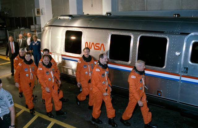 NASA image: STS-35 crew leaves KSC O&C Bldg and boards van for transport to LC Pad 39A