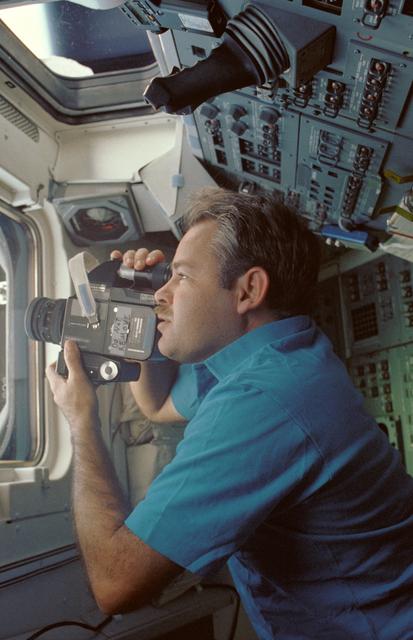 NASA image: STS-36 Commander Creighton uses 70mm HASSELBLAD camera on flight deck