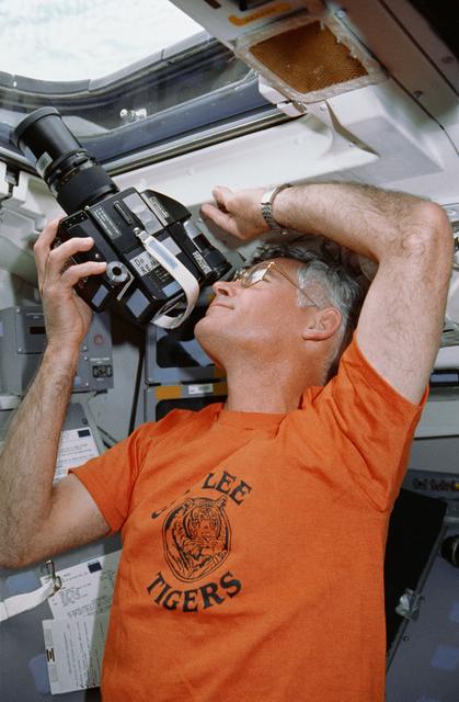 STS-36 Mission Specialist Mullane uses 70mm HASSELBLAD camera on flight deck