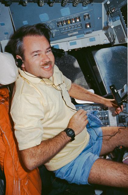 NASA image: STS-36 Commander Creighton listens to music on OV-104's forward flight deck