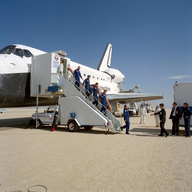 NASA image: STS-36 crewmembers egress Atlantis, OV-104, via stairway after EAFB landing
