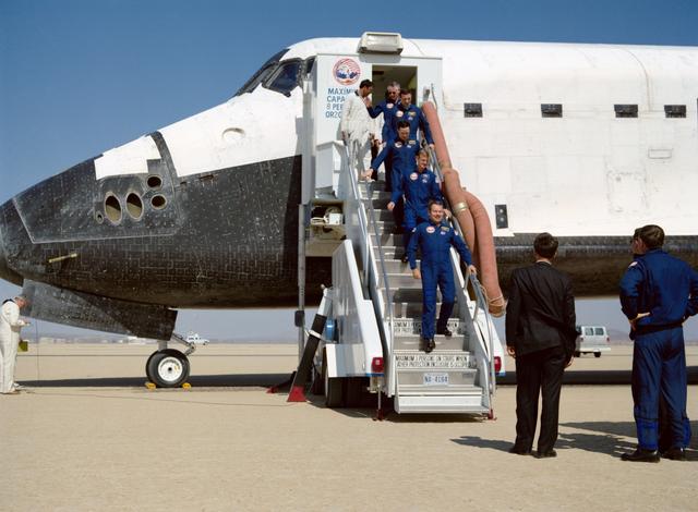 NASA image: STS-36 crewmembers egress Atlantis, OV-104, via stairway after EAFB landing