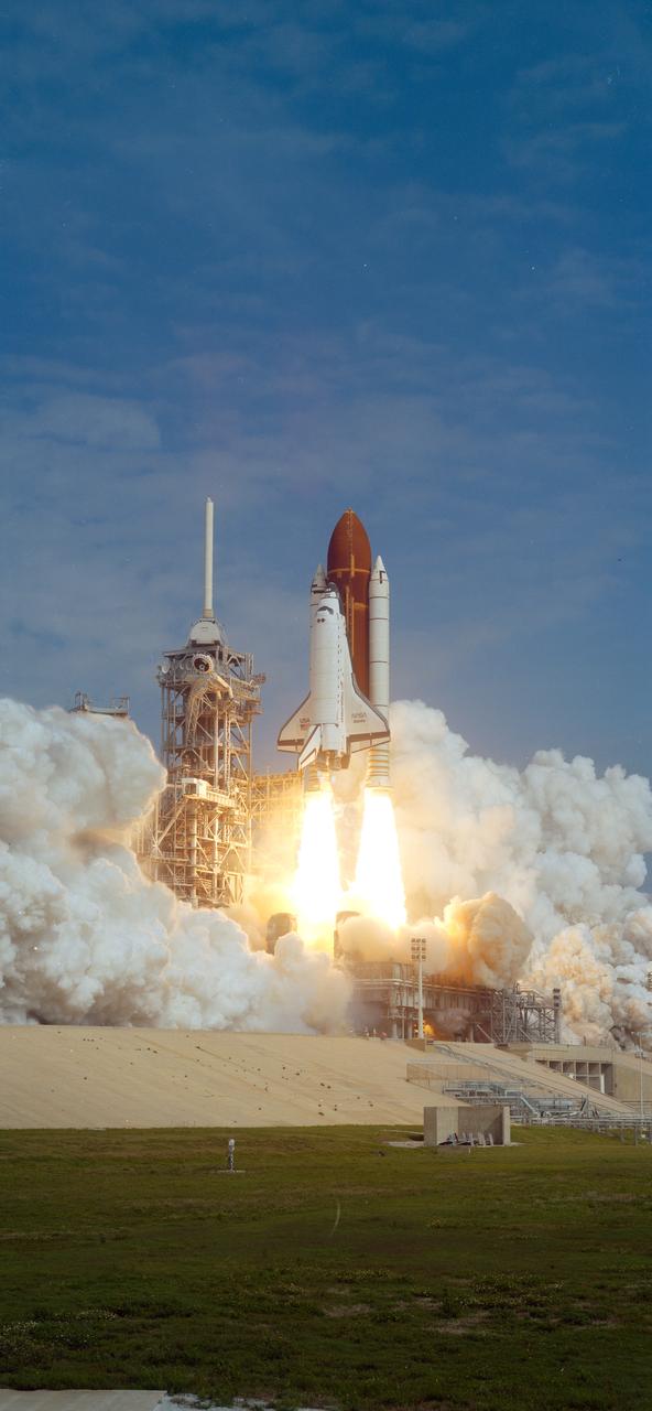 STS037-S-008 (5 April 1991) ---- A 70mm scene of the Space Shuttle Atlantis just about to clear the launch tower and soar on its way to a busy five-day mission in Earth orbit. Launch occurred at 9:22:45:0438 (EST), April 5, 1991. Onboard were five NASA astronauts, the Gamma Ray Observatory (GRO) and other experiments.