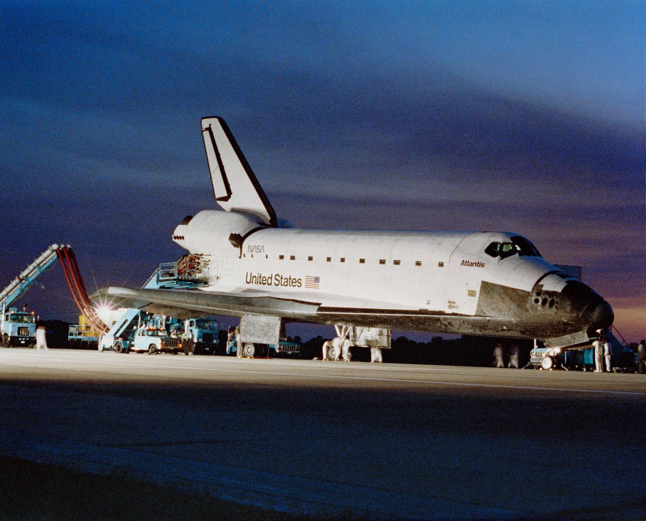 Spotlights illuminate Atlantis, Orbiter Vehicle (OV) 104, during safing operations at the Kennedy Space Center's (KSC's) Shuttle Landing Facility (SLF). OV-104 parked on runway 33 is serviced by KSC ground crews. STS-38, a Department of Defense (DOD)-devoted mission, came to an end (with complete wheel stop) at 4:43:37 pm (Eastern Standard Time (EST)).