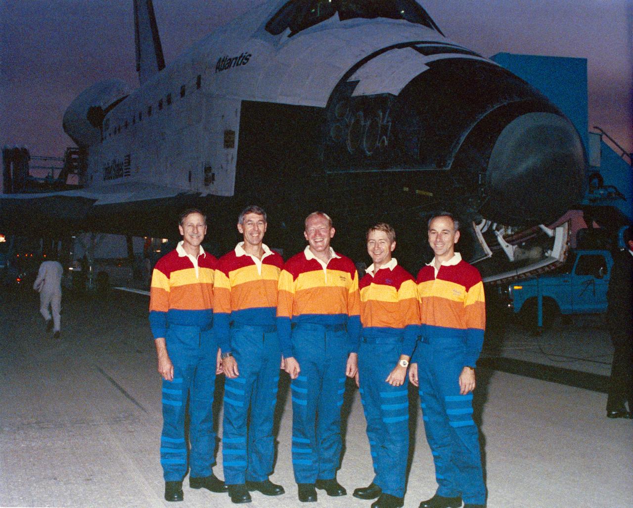 STS038-S-040 (20 Nov 1990) ---  STS-38 crewmembers, wearing red, yellow, and orange polo shirts, pose in front of Atlantis, Orbiter Vehicle (OV) 104, parked on runway 33 at Kennedy Space Center's (KSC) Shuttle Landing Facility (SLF) during post flight activities. Left to right are Commander Richard O. Covey, Mission Specialist (MS) Robert C. Springer, MS Charles D. Gemar, Pilot Frank L. Culbertson, and MS Carl J. Meade.