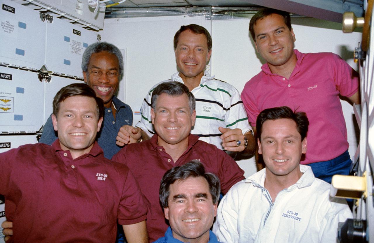 STS039-07-017 (28 April - 6 May 1991) --- The seven member astronaut crew for the STS-39 mission poses on the middeck of the Earth-orbiting space shuttle Discovery for an in-flight crew portrait.  Left to right (front) are astronauts Donald R. McMonagle, Michael L. Coats, Charles L. (Lacy) Veach and Gregory J. Harbaugh; and left to right (rear) are astronauts Guion S. Bluford Jr., L. Blaine Hammond and Richard J. Hieb. Photo credit: NASA