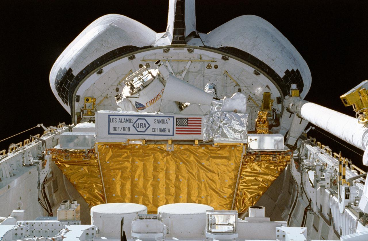 STS039-10-019 (28 April-6 May 1991) --- This 35mm frame, taken from inside the crew cabin, shows some of the cargo in Discovery's payload bay.  Seen are the tops of canisters on the STP-1 payload, configured on the STS 39 Hitchhiker carrier; and the Air Force Program (AFP) 675 package.  AFP-675 consists of the Cryogenic Infrared Radiance Instrumentation for Shuttle (CIRRIS)-1A; Far Ultraviolet Camera (FAR-UV) Experiment; Horizon  Ultraviolet Program (HUP); Quadruple Ion Neutral Mass Spectrometer (QINMS); and the Uniformly Redundant Array (URA).