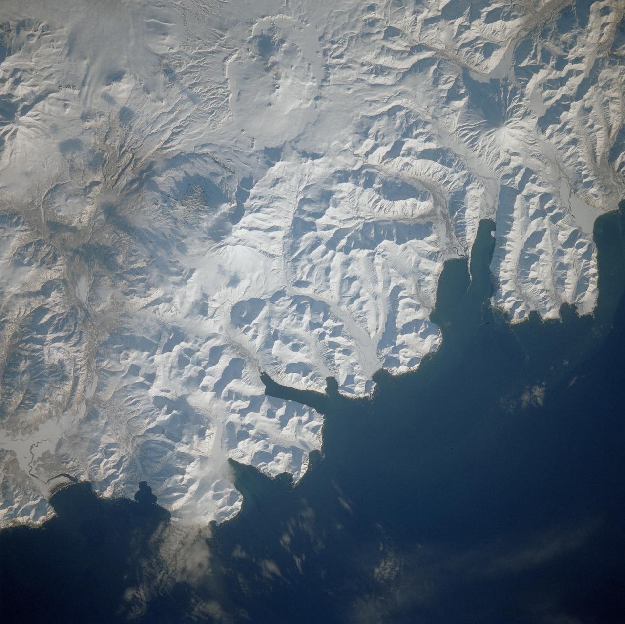 STS039-81-00OU (28 April-6 May 1991) --- Flying at an  inclination of 57 degrees to Earth's Equator, the Space Shuttle Discovery was able to record photography of a number of seldom observed areas on the planet, such as the USSR.  This view was taken in the far north Pacific Ocean and shows part of the Kamchatka Peninsula.  One of Discovery's seven crewmembers aimed a 70mm handheld camera through aft flight deck overhead windows to record the image.