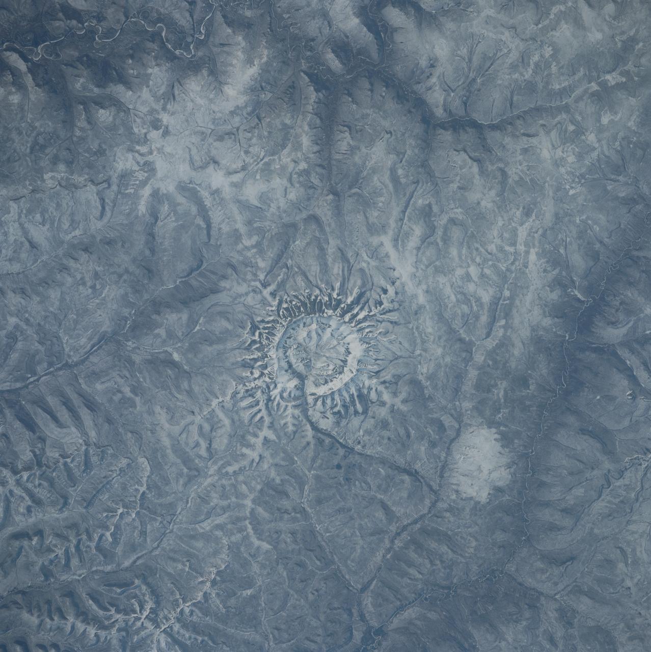 S39-84-29AE (28 April-6 May 1991) --- In the center of this 70mm frame, surrounded by mountainous terrain, is Gora Konder crater in the USSR.  The 57-degree inclination of Discovery's orbit allowed photographs of seldom observed areas of Earth such as this.  The picture was exposed with a 70mm handheld camera from overhead windows on Discovery's aft flight deck.