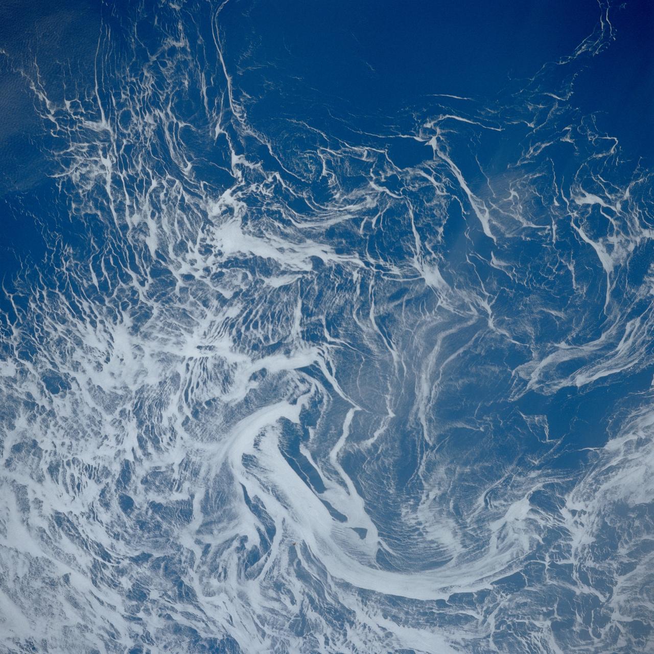 STS039-84-29AL (28 April-6 May 1991) --- This nearly vertical photograph of the North Atlantic, taken outside of the sunglint pattern, illustrates the extreme contrast between highly reflective ice, having a large percentage of between-crystal air space, and the low-reflectance water, which absorbs most of the light that propagates into it from the air.  The ice drifts along with the surface currents and wind and may therefore be used as a natural Langranian* tracer.  Photographs such as this, taken several times over the course of a mission, may be used to investigate near-surface circulation in high-latitude oceans.            *A Langranian tracer is anything that can be tracked as it drifts along with the water, as opposed to staying in one position and measuring how fast the water goes by.
