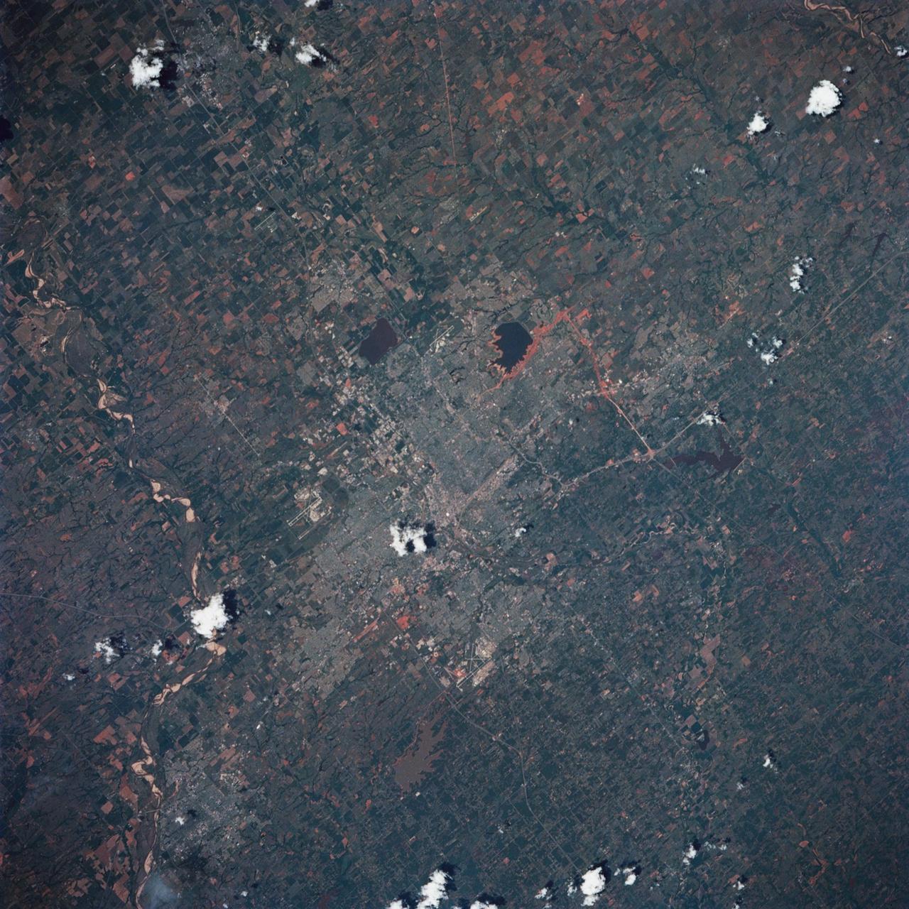 STS039-85-029 (28 April-6 May 1991) --- This 70mm frame is one of the best pictures of the Oklahoma City area from the manned space program, according  to NASA photo experts studying STS-39 onboard photography.  The central business district is near the  center.  Several municipalities are visible, along with thousands of acres of farmland.  The towns of Norman and Moore and the South Canadian River are in the bottom (south).  El Reno and Wiley Post Field off I-40W are just below center in lower left quadrant. Edmond is seen at the top (north).  Tinker Field can be seen north of I-40E at right center.  Lake Overholser shows recent spring rainfall northwest of the central business district.