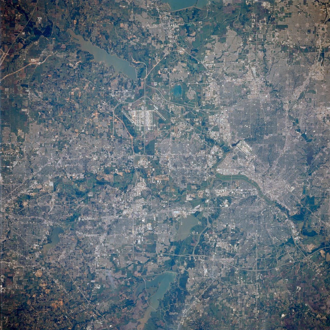 STS039-85-032 (28 April-6 May 1991) --- A large portion of the Dallas - Fort Worth metropolitan area is seen in this 70mm frame, photographed from the Earth-orbiting Space Shuttle Discovery.  Hold photograph with the Dallas - Ft. Worth Airport directly above the center point of the picture so that north will be at the top.  Compared with Apollo 6 pictures made 23 years earlier (April 1968), this photo indicates notable growth in the municipalities between Dallas and Ft. Worth as well as great outer growth of the two cities.  (Most of the western portions of Ft. Worth did not make it into this frame).  Easily recognizable bodies of water are Grapevine Lake and North Lake (both near the huge airport), Mountain Creek Lake (southwest of Dallas), Lake Arlington (southeast of Ft. Worth) and the Trinity River which flows southward to the Gulf of Mexico.