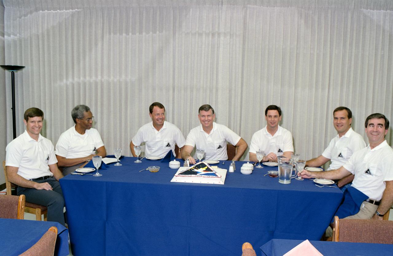 STS039-S-051 (28 April 1991) --- In KSC's Operations and Checkout Building, a very light breakfast is shared by the seven members of the STS-39 flight crew prior to their April 28, 1991 launch.  Left to right are   astronauts Donald R. McMonagle, Guion S. Bluford Jr., L. Blaine Hammond, Michael L. Coats, Gregory J. Harbaugh, Richard J. Hieb and Charles L. (Lacy) Veach.  Launch occurred at 7:33:14 a.m. (EDT), April 28, 1991.