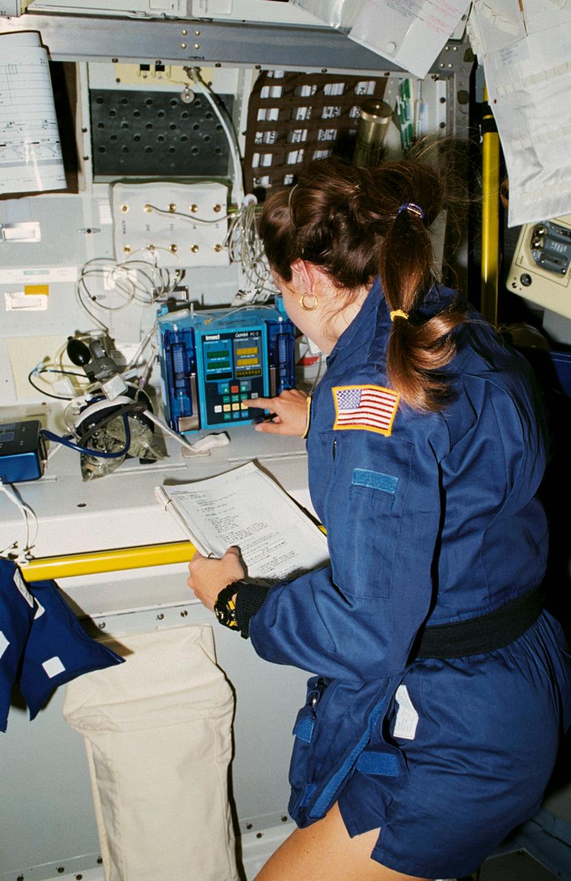 STS040-30-008 (5-14 June 1991) --- Astronaut Tamara E. Jernigan, after applying a blood pressure cuff to an experiment, watches it in operation.  The experiment is the intravenous infusion pump. The device is being considered for use on Space Station Freedom's Health Maintenance Facility.  Dr. Jernigan is one of seven crew members supporting the nine-day Spacelab Life Sciences (SLS-1) mission aboard the Earth-orbiting Space Shuttle Columbia.
