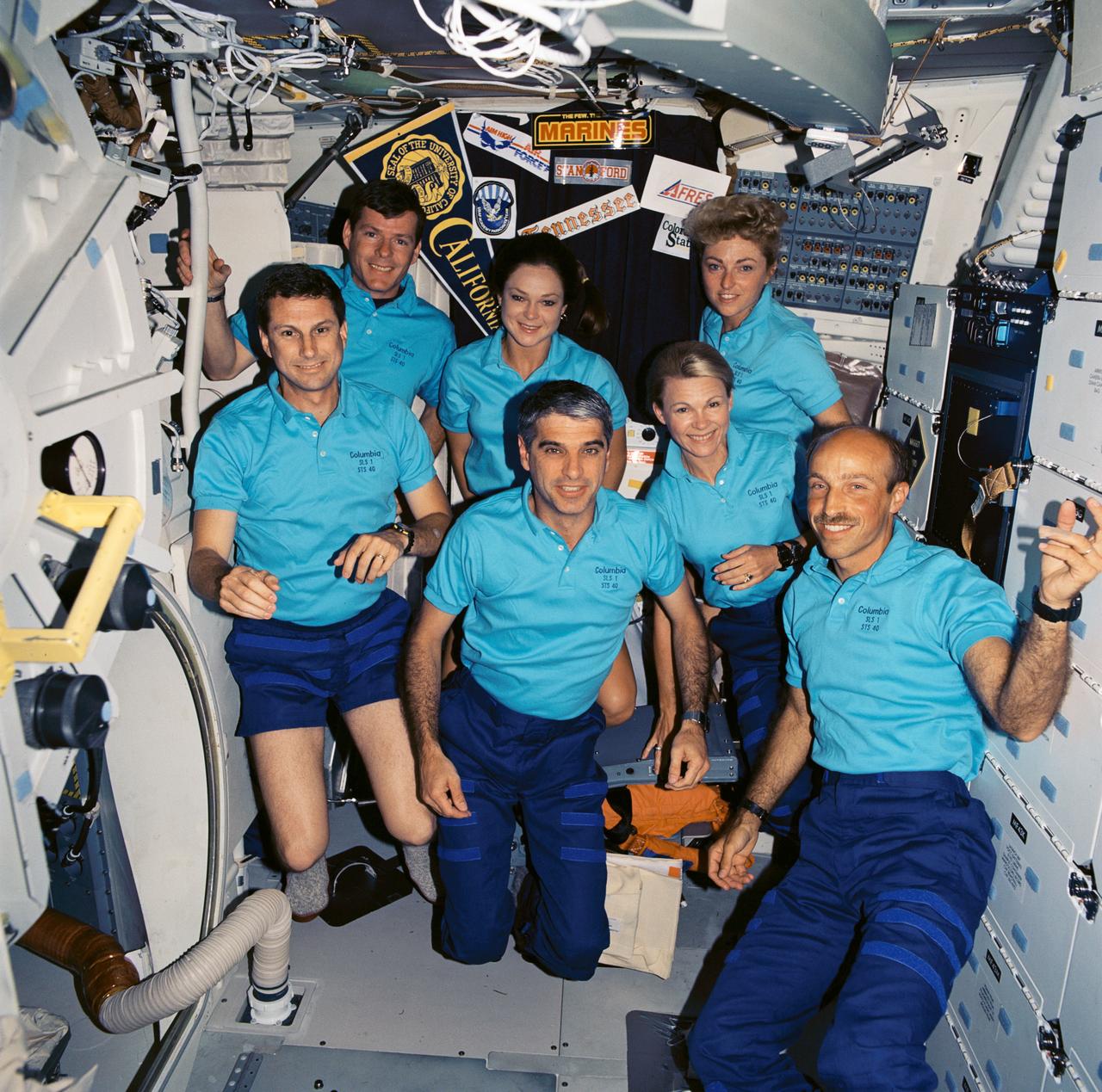 STS040-605-009 (5-14 June 1991) --- The seven crew members for STS-40 pose for an in-space portrait on the Space Shuttle Columbia's mid-deck.  Left to right, in front are F. Andrew Gaffney, Sidney M. Gutierrez, Rhea Seddon and James P. Bagian; in back, Bryan D. O'Connor, Tamara E. Jernigan and Millie Hughes-Fulford.  The five astronauts and two payload specialists are spending nine days in space in support of the Spacelab Life Sciences (SLS-1) mission.  The image was one of 25 visuals used by the STS-40 crew at its Post Flight Press Conference (PFPC) on June 28, 1991.