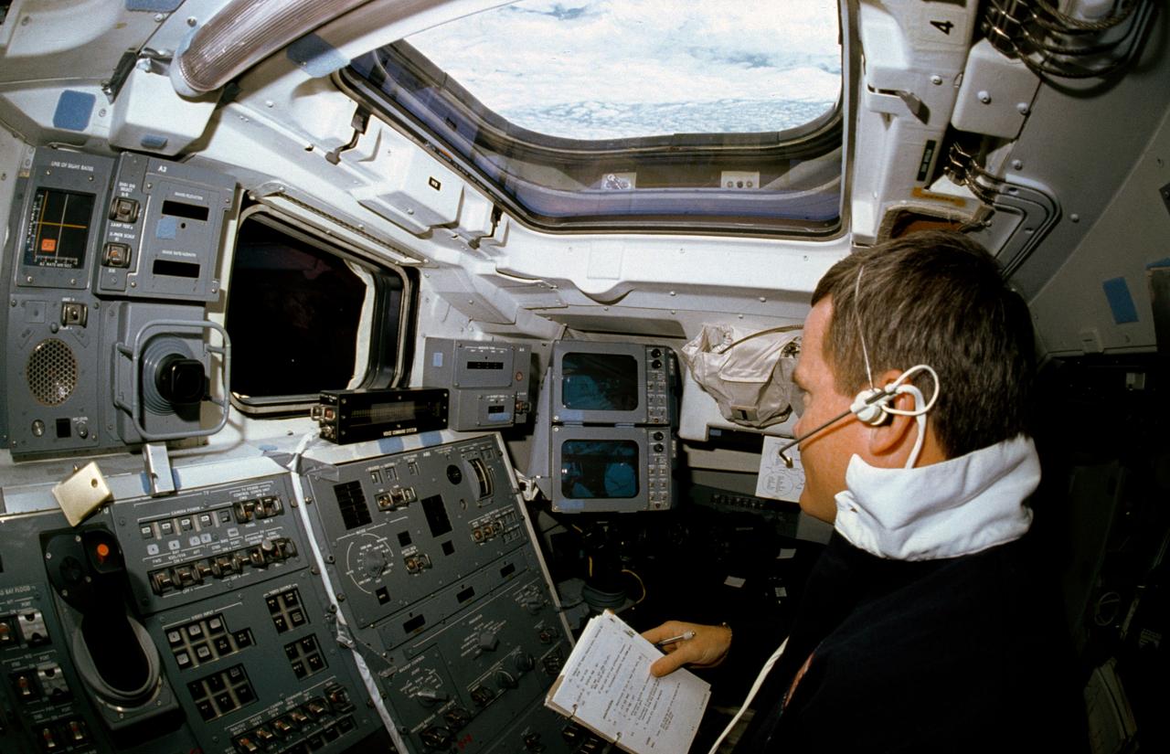 STS041-02-028 (6-20 Oct 1990) --- Astronaut Bruce E. Melnick, STS-41 mission specialist, participates in a voice command system (VCS) test on Discovery's aft flight deck.  Melnick's voice is interpreted into a command that is able to control a video camera.