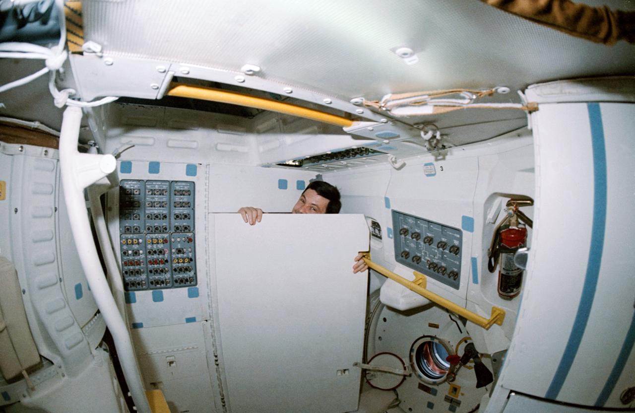 STS-41 crewmembers conduct Detailed Supplementary Objective (DSO) 0472 Intraocular Pressure on the middeck of Discovery, Orbiter Vehicle (OV) 103. Mission Specialist (MS) William M. Shepherd rests his head on the stowed treadmill while Pilot Robert D. Cabana, holding Shepherd's eye open, prepares to measure Shepherd's intraocular pressure using a tono pen (in his right hand). Objectives include: establishing a database of changes in intraocular pressures that can be used to evaluate crew health; validating ten degree head down bedrest as a model for cephalad fluid shifts in microgravity; facilitating the interpretation of data by providing a quantative measure of microgravity induced cephalad fluid shifts; and validating the tono pen as an effective tool for diagnostic and scientific data collection.