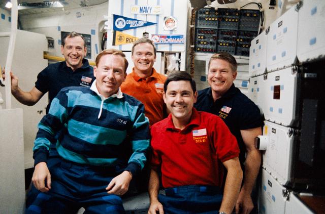 STS-41 crewmembers pose on OV-103's middeck for inflight (in-space) portrait
