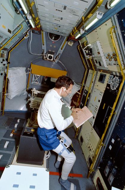 NASA image: STS-42 Mission Specialist (MS) Hilmers reviews checklist in IML-1 module
