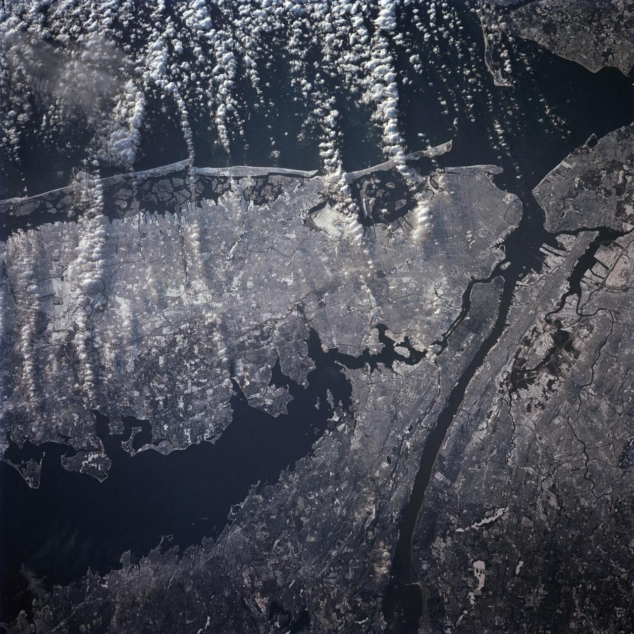 STS-42 Earth observation taken aboard Discovery, Orbiter Vehicle (OV) 103, is of New York City (NYC), New York (41.0N, 74.0W). Snow cover highlights the large areas of development and the many reservoirs in this wintertime scene of the metropolitan NYC area. Features such as Central Park in Manhattan, the George Washington Bridge connecting Manhattan with New Jersey, street patterns in most of the boroughs, La Guardia and JFK airports in Queens, and the extensive harbor system are easily identified.
