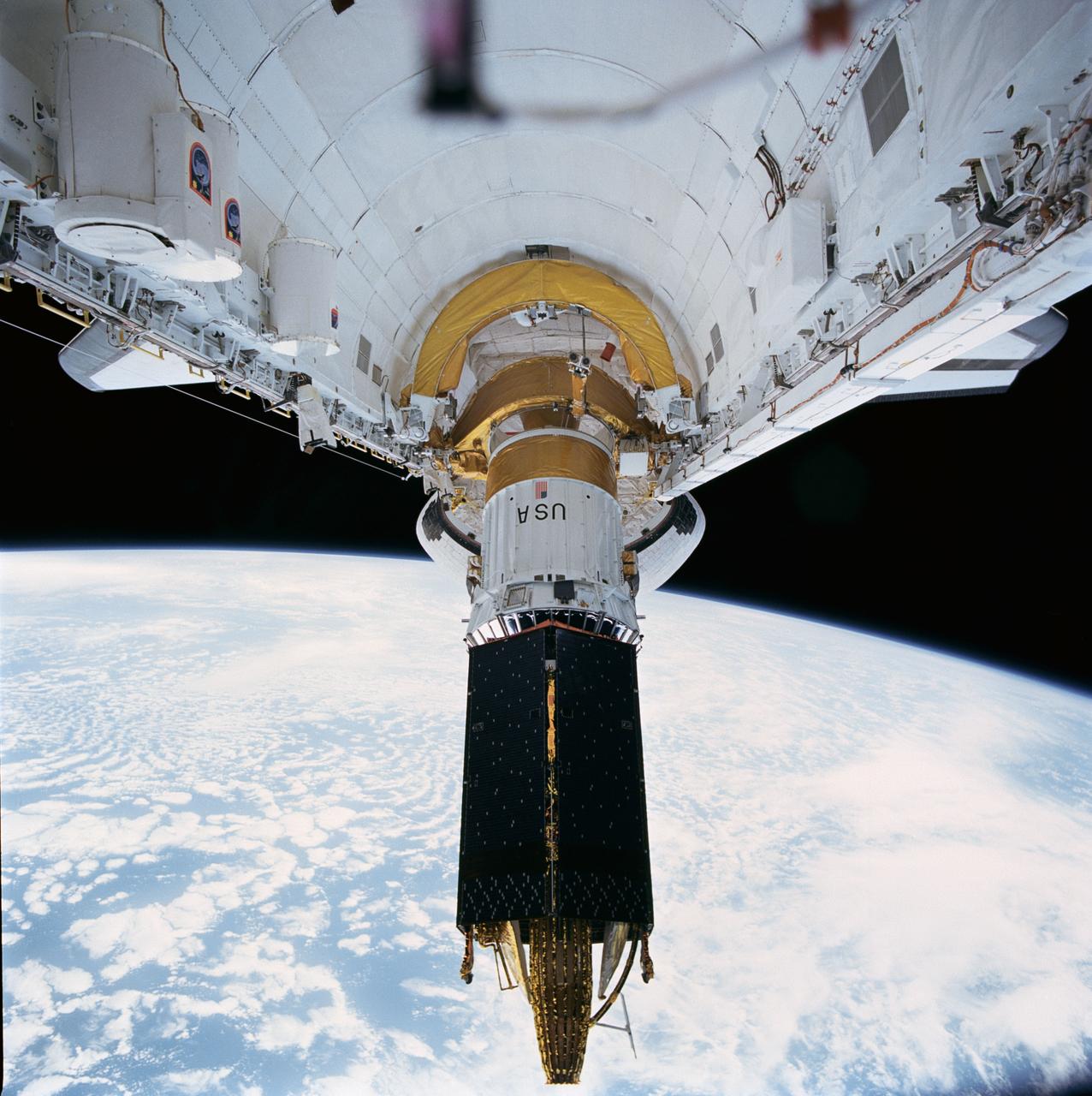 STS043-72-020 (2 Aug 1991) --- The Tracking and Data Relay Satellite (TDRS-E), is loosened from its restraint device and begins to leave the payload bay of the earth-orbiting Atlantis.  The deployment came a mere six hours after the Space Shuttle was launched from Pad 39A at Kennedy Space Center, Florida.  TDRS, built by TRW, will be placed in a geosynchronous orbit and after on-orbit testing, which requires several weeks, will be designated TDRS-5.  The communications satellite will replace TDRS-3 at 174 degrees West longitude.  The backbone of NASA's space-to-ground communications, the Tracking and Data Relay satellites have increased NASA's ability to send and receive data to spacecraft in low-earth orbit to more than 85 percent of the time.  The five astronauts of the STS 43 mission are John E. Blaha, mission commander, Michael A. Baker, pilot, and Shannon W. Lucid, G.  David Low, and James C.  Adamson, all mission specialists.