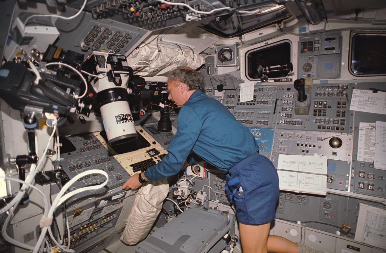 STS045-38-033 (24 March-2 April 1992) --- Dirk Frimout, European Space Agency (ESA) payload specialist, routes Grille operations through the data display unit (DDU) on Atlantis' flight deck. The Grille spectrometer is an ESA experiment. Frimout and six other crewmembers spent nine days in Earth orbit in support of the Atmospheric Laboratory for Applications and Science (ATLAS-1).