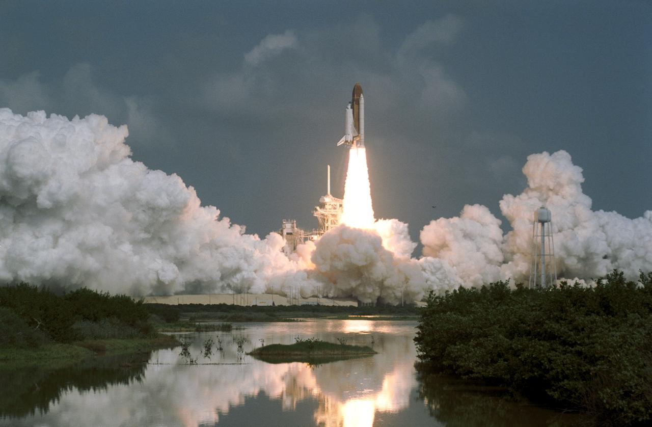 STS046-S-082 (31 July 1992) --- This panoramic scene at Kennedy Space Center's Launch Complex 39 shows the Space Shuttle Atlantis as it blasts off on its way to eight days of Earth orbital operations with a crew of five NASA astronauts and two European scientists onboard.  Launch occurred at 9:56:47:976 a.m. (EDT), July 31, 1992.  Onboard the spacecraft were astronauts Loren J. Shriver, Andrew M. Allen, Jeffrey A. Hoffman, Marsha S. Ivins and Franklin R. Chang-Diaz, along with the European Space Agency's Claude Nicollier and the Italian Space Agency's Franco Malerba.