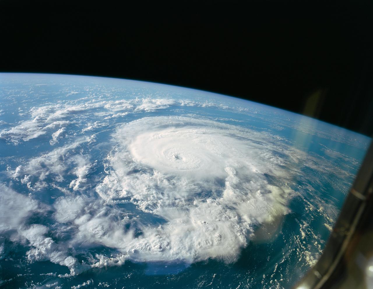 STS047-151-618 (19 Sept 1992) --- A large format Earth observation camera captured this scene of Hurricane Bonnie during the late phase of the mission.  Bonnie was located about 500 miles from Bermuda near a point centered at 35.4 degrees north latitude and 56.8 degrees west longitude.  The Linhof camera was aimed through one of Space Shuttle Endeavour's aft flight deck windows (note slight reflection at right).  The crew members noticed the well defined eye in this hurricane, compared to an almost non-existent eye in the case of Hurricane Iniki, which was relatively broken up by the mission's beginning.  Six NASA astronauts and a Japanese payload specialist conducted eight days of in-space research.