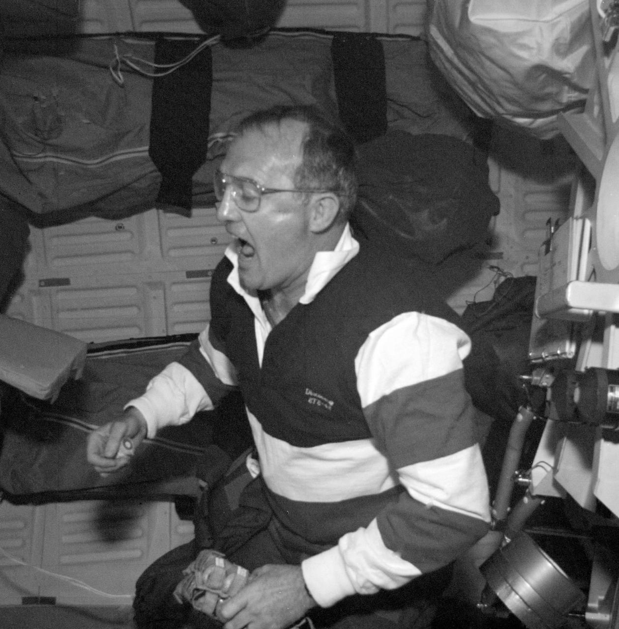 S48-E-007 (12 Sept 1991) --- Astronaut James F.  Buchli, mission specialist, catches snack crackers as they float in the weightless environment of the earth-orbiting Discovery. This image was transmitted by the Electronic Still Camera, Development Test Objective (DTO) 648.  The ESC is making its initial appearance on a Space Shuttle flight.   Electronic still photography is a new technology that enables a camera to electronically capture and digitize an image with resolution approaching film quality.  The digital image is stored on removable hard disks or small optical disks, and can be converted to a format suitable for downlink transmission or enhanced using image processing software. The Electronic Still Camera (ESC) was developed by the Man- Systems Division at the Johnson Space Center and is the first model in a planned evolutionary development leading to a family of high-resolution digital imaging devices. H. Don  Yeates, JSC's Man-Systems Division, is program manager for the ESC.   THIS IS A SECOND GENERATION PRINT MADE FROM AN ELECTRONICALLY PRODUCED NEGATIVE