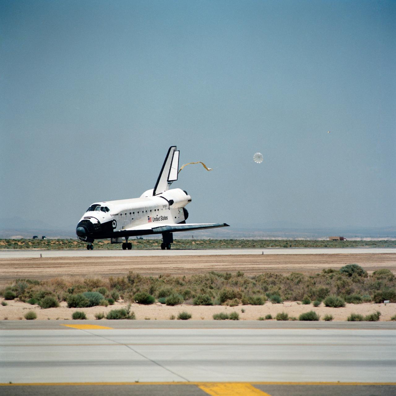 STS049-S-268 (16 May 1992) --- A three-quarter forward view of the Space Shuttle Endeavour making its first landing, following a successful nine-day mission in Earth orbit.  The drogue chute precedes the main chute in NASA's first exercise of its detailed test objective (DTO-521) on the drag chute system.  Main gear touchdown occurred at 1:57:38 p.m. (PDT), May 16, 1992.