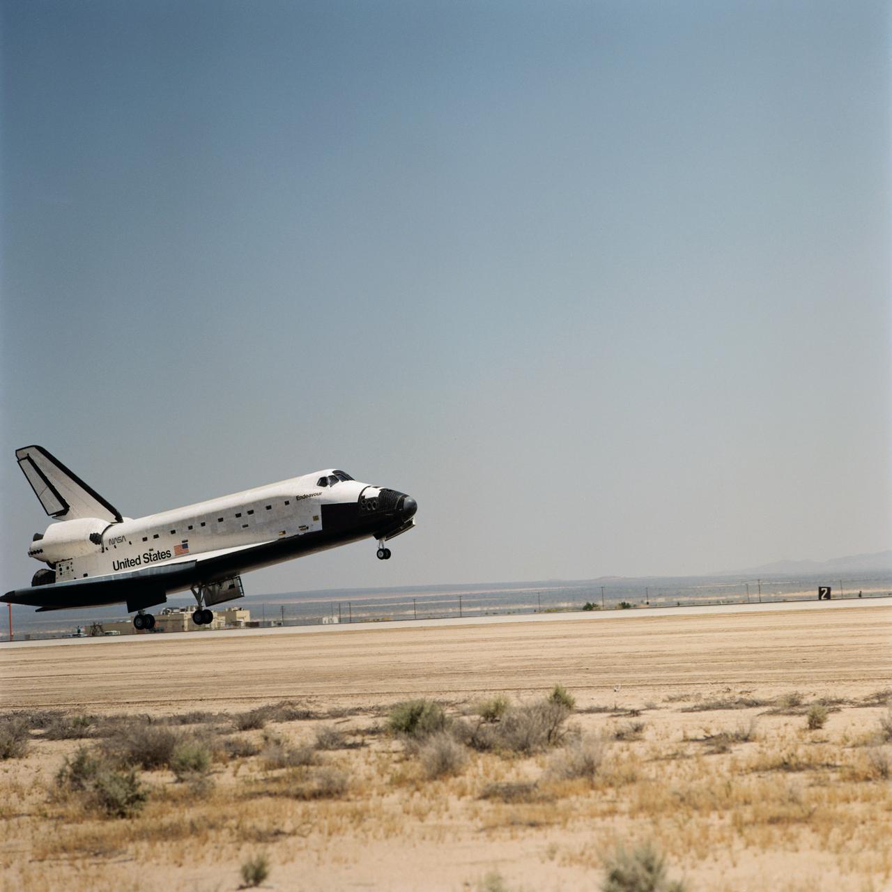 STS049-S-325 (16 May 1992) --- The main landing gear of Endeavour is just about to touch down at Edwards Air Force Base to draw to an end NASA's nine-day STS-49 mission. Crewmembers onboard were astronauts Daniel C. Brandenstein, mission commander; Kevin P. Chilton, pilot; and Thomas D. Akers, Richard J. Hieb, Bruce E. Melnick, Kathryn C. Thornton and Pierre J. Thout, all mission specialists.  Landing occurred at 1:36:38 p.m. (PDT), May 16, 1992.