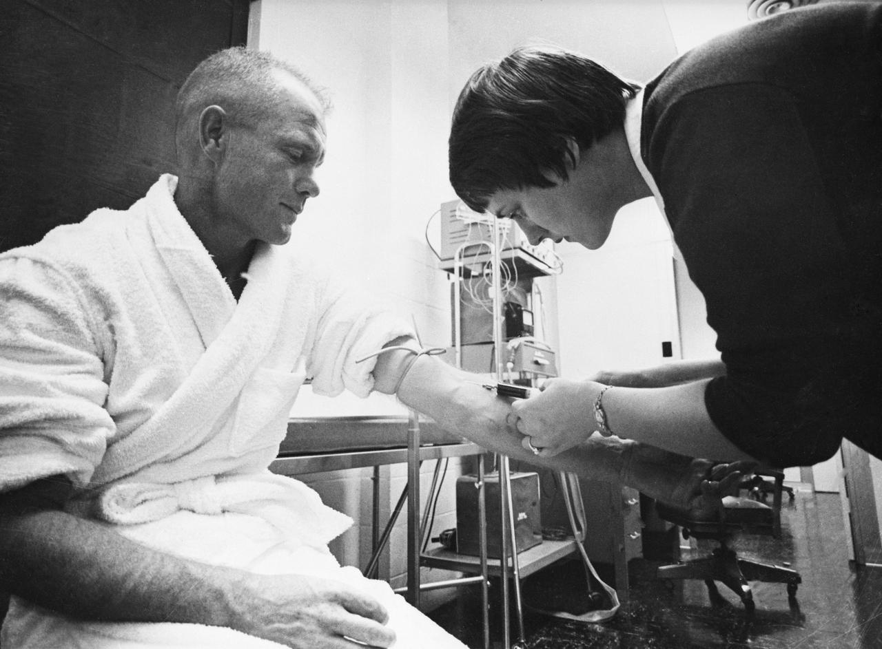 S61-02579 (1961) --- Astronaut nurse Delores B. O'Hara, R.N., in the Aeromedical Laboratory at Cape Canaveral, Florida, takes a blood sample from Mercury astronaut John H. Glenn Jr. Photo credit: NASA