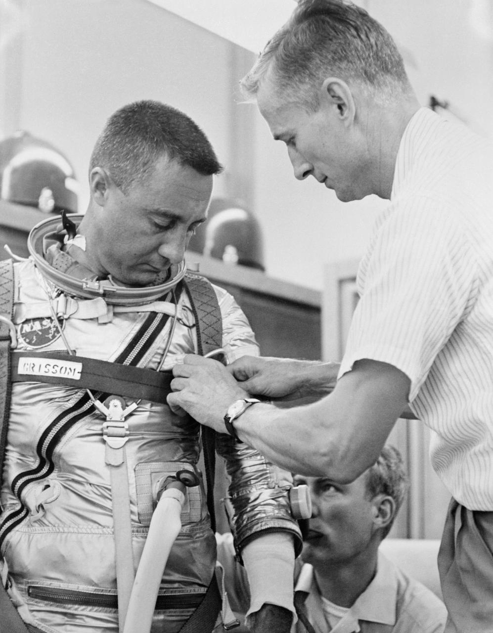 S61-02839 (1961) --- Astronaut Virgil I. (Gus) Grissom, pilot of the Mercury-Redstone 4 (MR-4) spaceflight, suits up for MR-4 simulation training. Assisting is suit technician Joe Schmitt. Photo credit: NASA