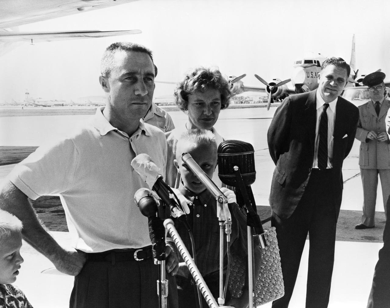S61-03684 (21 July 1961) --- Astronaut Virgil I. (Gus) Grissom and his family are shown at the airport at Patrick Air Force Base with NASA Administrator James E. Webb (right). Grissom is speaking into microphones for the news media. Photo credit: NASA