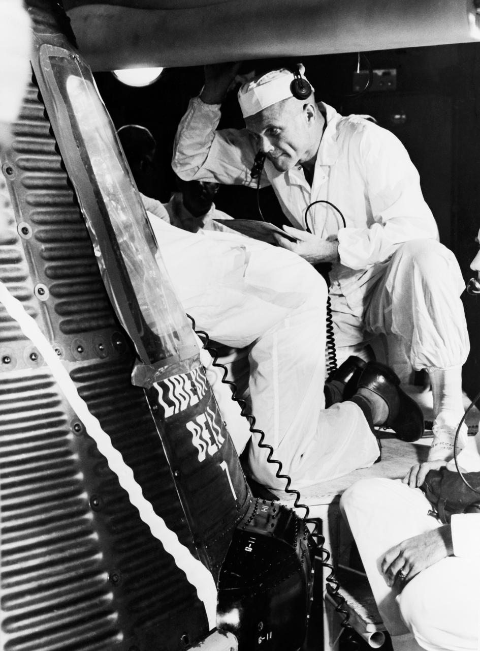 S61-03740 (20 July 1961) --- Astronaut John H. Glenn Jr. and a technician examine the interior of the Liberty Bell 7, the capsule flown a few days later during the Mercury-Redstone 4 mission with astronaut Virgil I. (Gus) Grissom. Photo credit: NASA