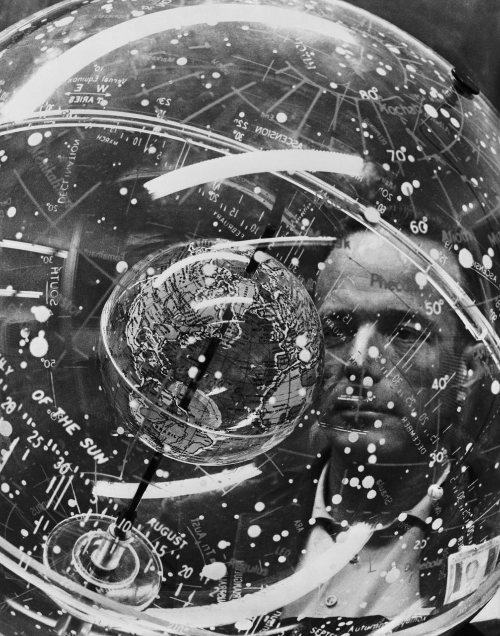 S61-04621 (1961) --- Astronaut M. Scott Carpenter looks into a Celestial Training Device (globe) during training in the Aeromedical Laboratory at Cape Canaveral, Florida. Photo credit: NASA