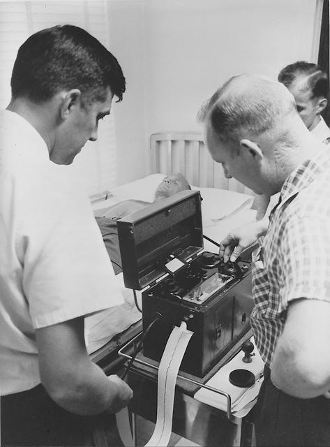 S61-03621 (1961) --- Astronaut John H. Glenn Jr. having an electrocardiograph done by Dr. Jackson during medical testing at the Pensacola Naval Station. Photo credit: NASA
