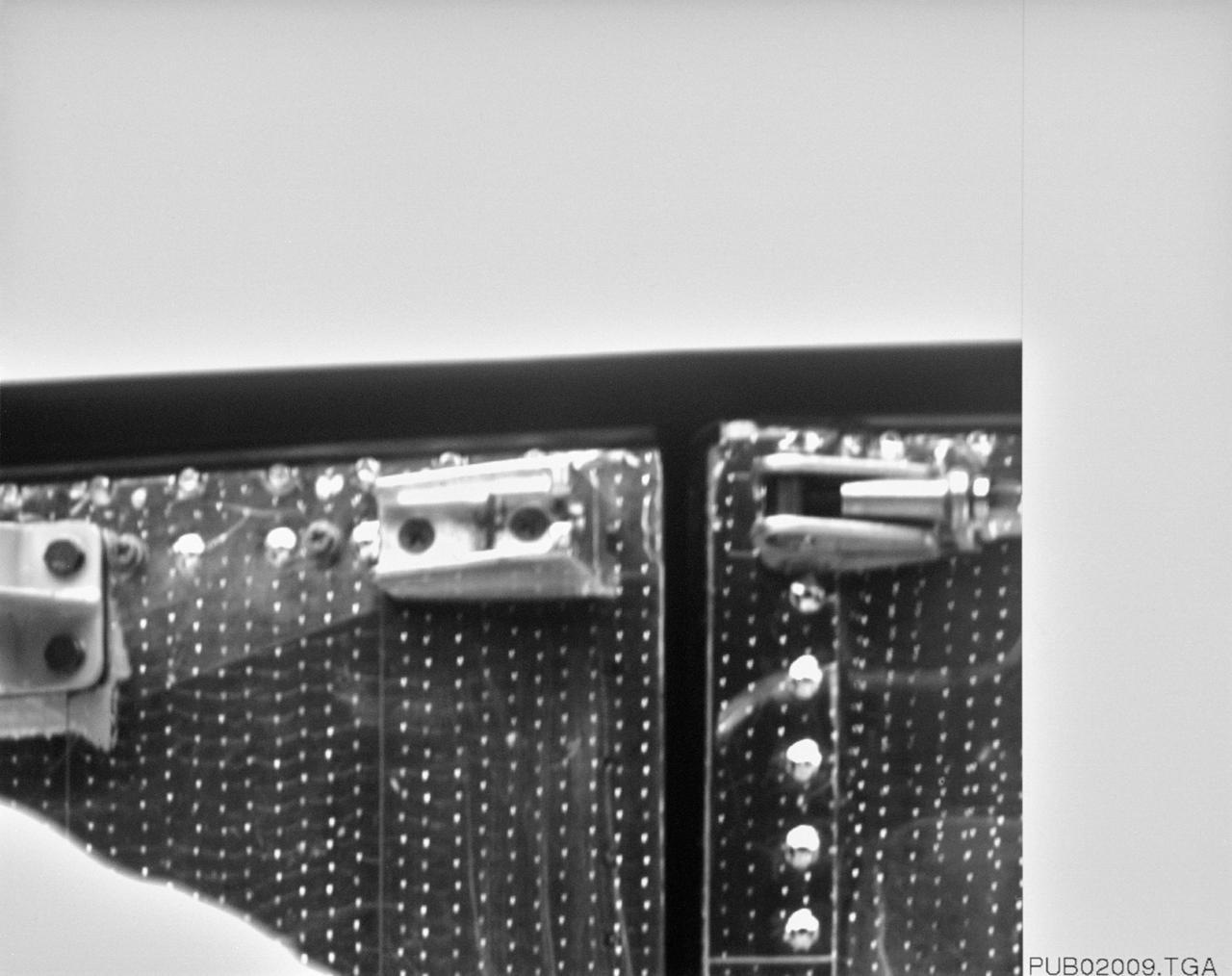 S61-E-004 (4 Dec 1993) --- This close-up view of a latch on the minus V3 aft shroud door of the Hubble Space Telescope (HST) was photographed with an Electronic Still Camera (ESC), and down linked to ground controllers soon afterward. Endeavour's crew captured the HST on December 4, 1993 in order to service the telescope. Over a period of five days, four of the seven crew members will work in alternating pairs outside Endeavour's shirt sleeve environment to service the giant telescope. Electronic still photography is a relatively new technology which provides the means for a handheld camera to electronically capture and digitize an image with resolution approaching film quality. The electronic still camera has flown as an experiment on several other shuttle missions.