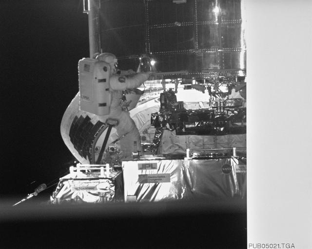 NASA image: Astronaut Jeffrey Hoffman on RMS robot arm during HST repairs