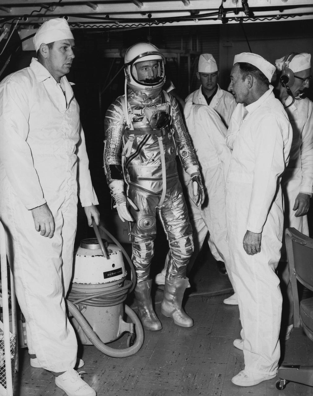 S62-00120 (1961) --- Astronaut M. Scott Carpenter, prime pilot for the Mercury-Atlas 7 (MA-7) spaceflight, is seen in Hangar S crew quarters during a suiting exercise at Cape Canaveral, Florida. Photo credit: NASA