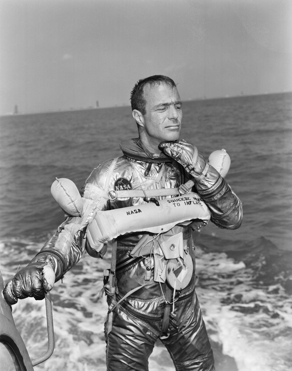 S62-01358 (1962) --- Project Mercury astronaut M. Scott Carpenter, prime pilot of the Mercury-Atlas 7 (MA-7) spaceflight, goes through a water egress test. He is in the Mercury pressure suit, without the helmet, and is wearing a life vest. Photo credit: NASA