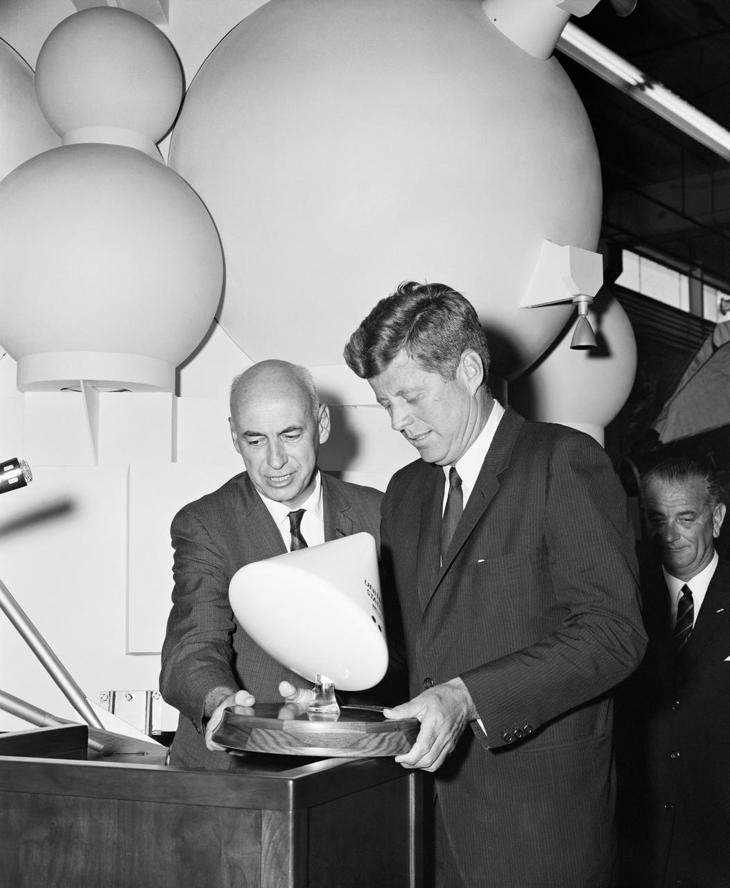 S62-03984 (12 September 1962) --- Dr. Robert R. Gilruth (left), MSC Director, presented President John F. Kennedy with this mounted model of the Apollo spacecraft at the end of the president's visit.  Kennedy said, "We will take this back to the White House as a reminder of most extraordinary efforts being made by the men of NASA here and all across the country."