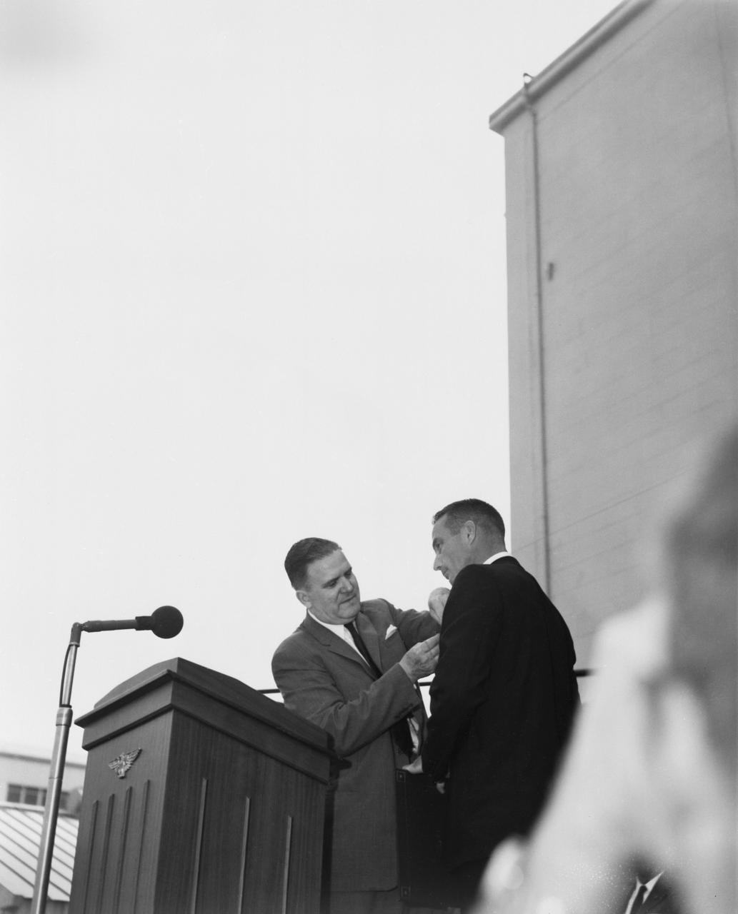 S62-04114 (1962) --- Astronaut M. Scott Carpenter, pilot of the Mercury-Atlas 7 (MA-7) mission, receives the NASA Distinguished Service Medal from NASA Adminstrator James E. Webb during ceremonies at Cape Canaveral, Florida. Photo credit: NASA